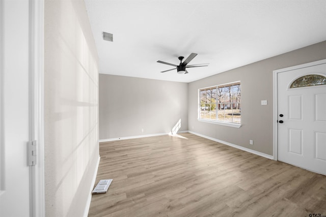 foyer entrance with ceiling fan and light hardwood / wood-style floors