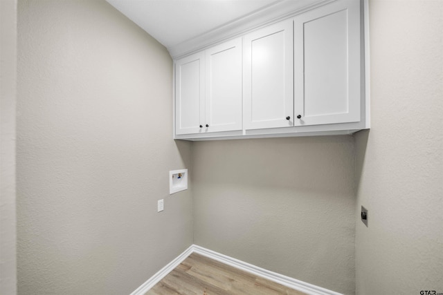 laundry room featuring washer hookup, light hardwood / wood-style flooring, cabinets, and hookup for an electric dryer