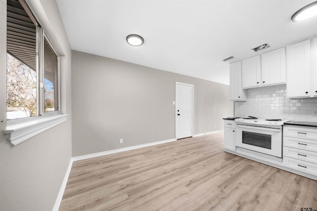 kitchen featuring white range with electric cooktop, white cabinets, tasteful backsplash, and light hardwood / wood-style flooring