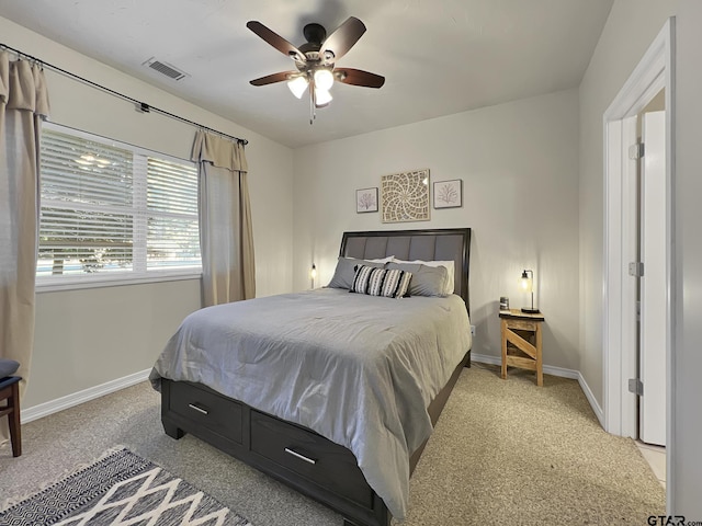 bedroom featuring a ceiling fan, light carpet, visible vents, and baseboards