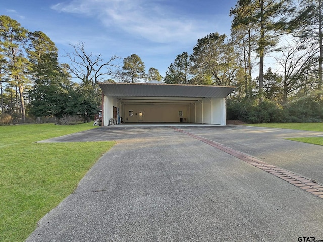 garage with driveway and an attached carport