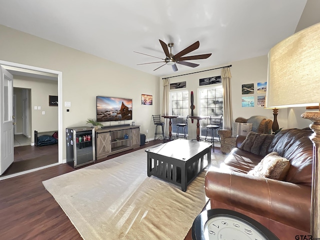 living room featuring ceiling fan, wood finished floors, and baseboards