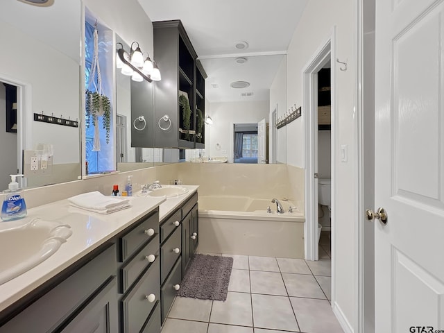 bathroom featuring double vanity, toilet, tile patterned floors, a sink, and a bath