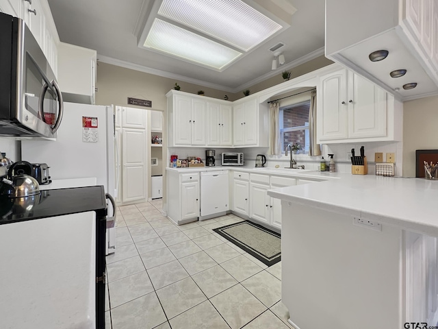 kitchen with black range with electric cooktop, a peninsula, a sink, ornamental molding, and stainless steel microwave