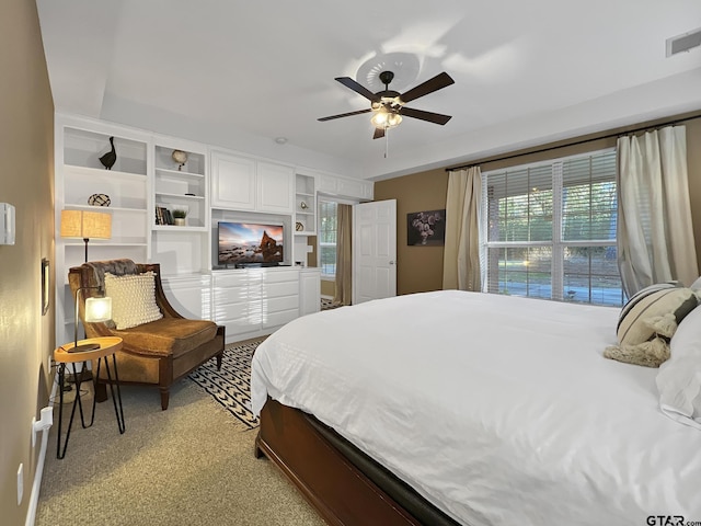 bedroom featuring light carpet, visible vents, and a ceiling fan