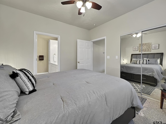 carpeted bedroom featuring ceiling fan and ensuite bathroom