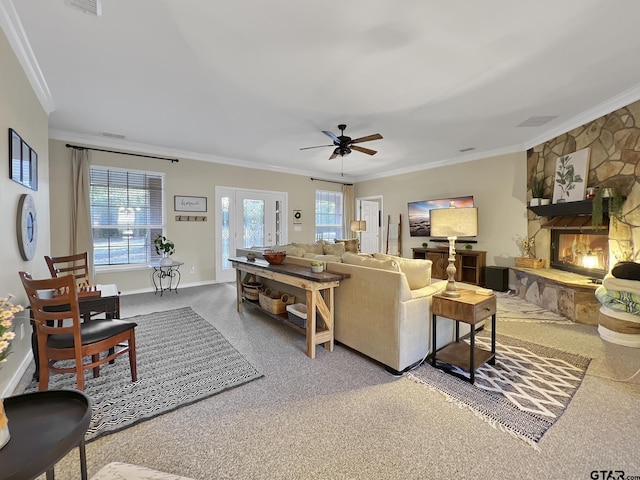 living room with baseboards, a fireplace, ornamental molding, and a wealth of natural light