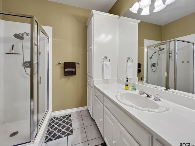 full bathroom with baseboards, a shower stall, vanity, and tile patterned floors