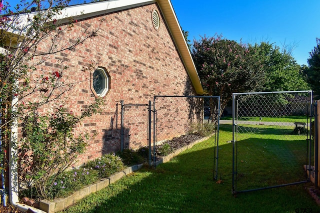 view of side of home with a yard