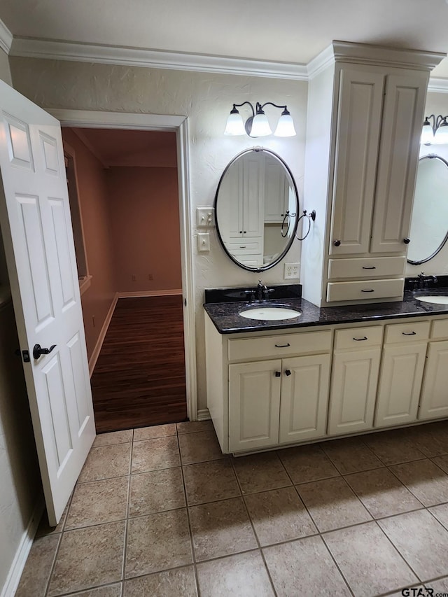 bathroom with tile patterned flooring, vanity, and ornamental molding