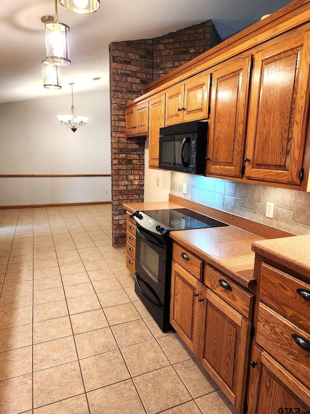 kitchen featuring black appliances, light tile patterned floors, hanging light fixtures, and tasteful backsplash