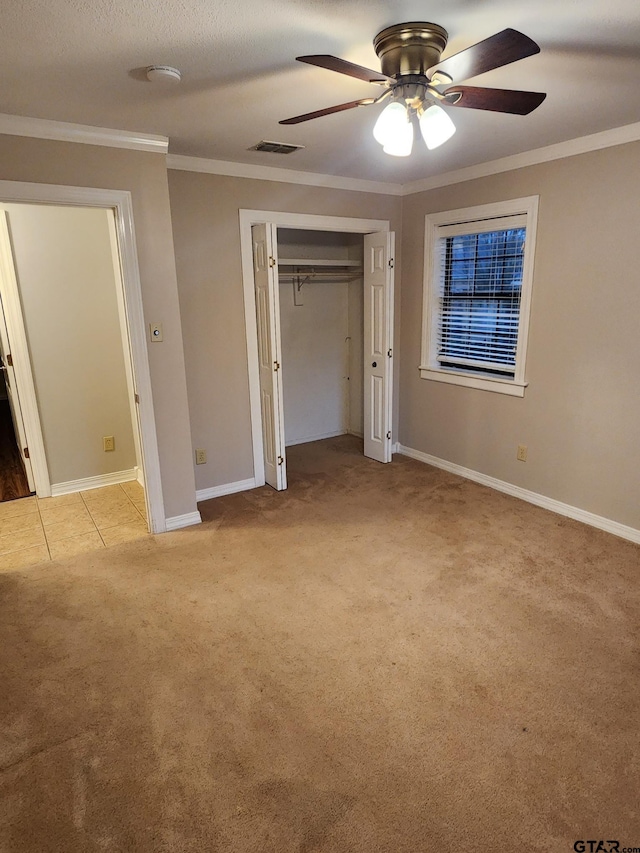 unfurnished bedroom featuring light carpet, ceiling fan, and ornamental molding