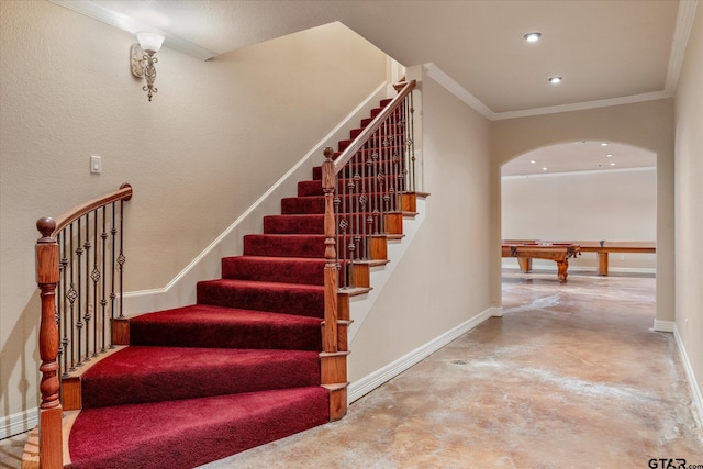 stairway with pool table and ornamental molding