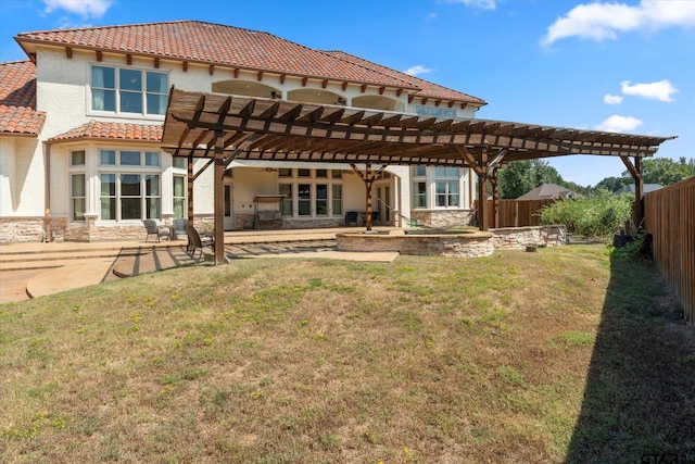 rear view of property featuring a patio area, a pergola, and a yard