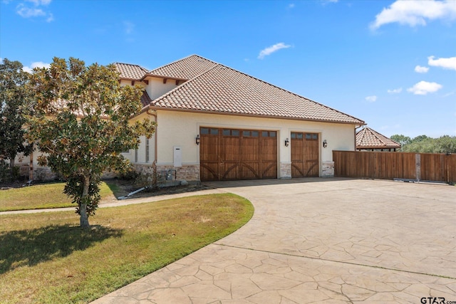 view of side of home with a garage and a yard