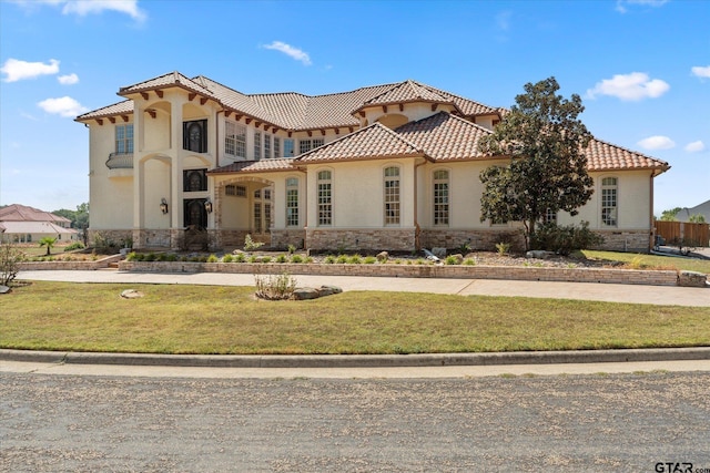 mediterranean / spanish house with a front lawn