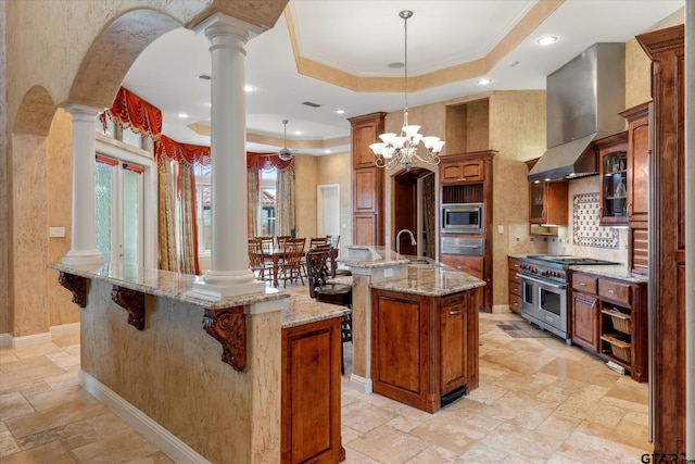 kitchen with hanging light fixtures, a notable chandelier, a center island with sink, and stainless steel appliances