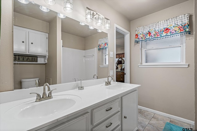 113 Granada Sq, Canton, TX 75103 - bathroom with double vanity, baseboards, toilet, a shower, and tile patterned flooring