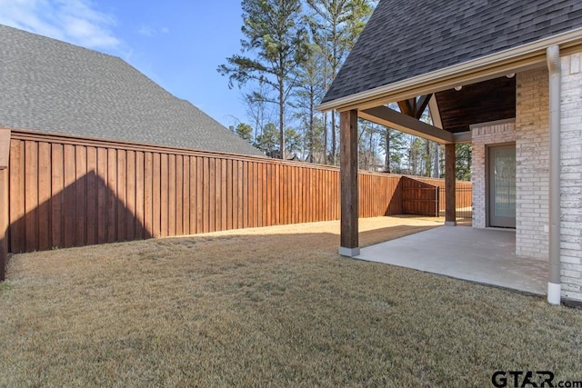 view of yard with a fenced backyard and a patio