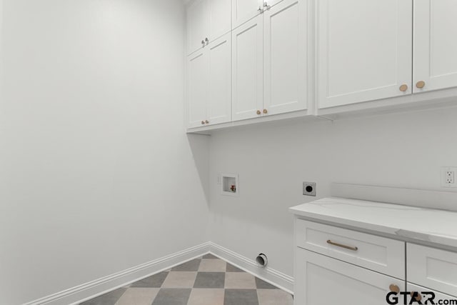 laundry area with cabinet space, dark floors, baseboards, hookup for an electric dryer, and hookup for a washing machine