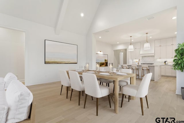 dining space with beam ceiling, visible vents, recessed lighting, and light wood-type flooring