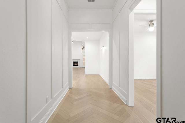 hall featuring visible vents and baseboards