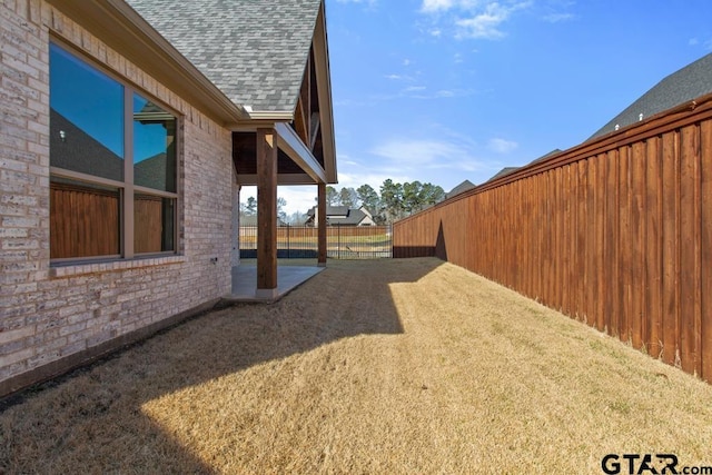 view of yard with a patio and fence