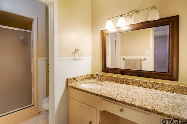 315 Ridgecrest Dr, Tyler, TX 75701 - bathroom featuring vanity, a stall shower, and wainscoting