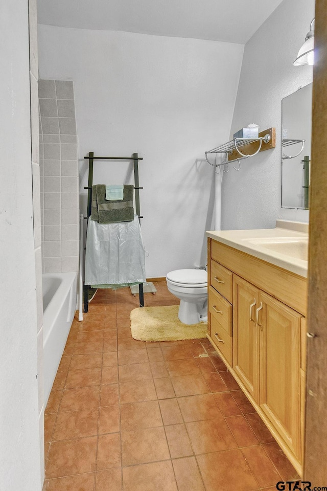 bathroom featuring vanity, toilet, and tile patterned flooring