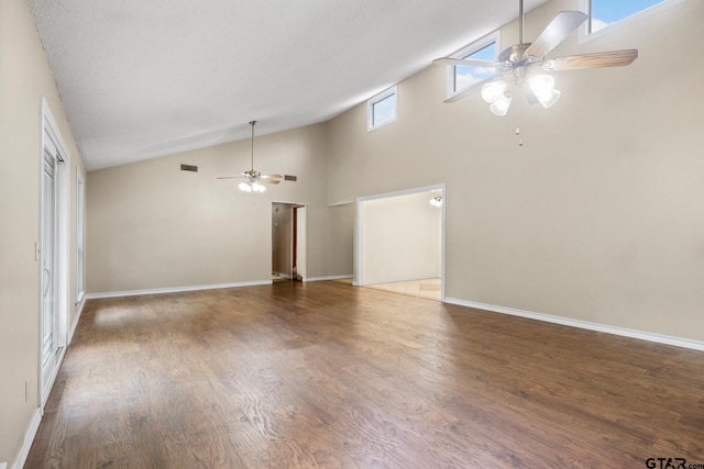 unfurnished living room with ceiling fan, dark hardwood / wood-style flooring, and high vaulted ceiling