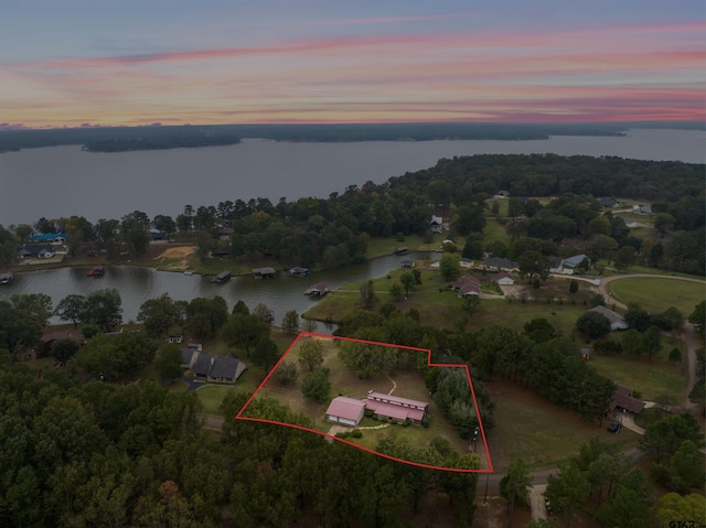 aerial view at dusk with a water view