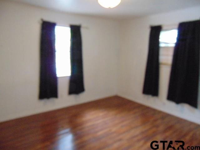 spare room featuring wood finished floors