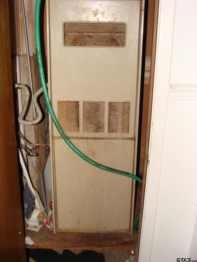 utility room featuring heating unit