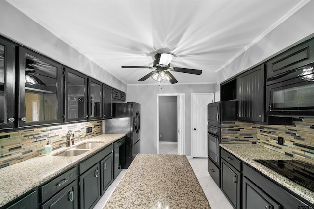 kitchen featuring sink, ceiling fan, light stone counters, ornamental molding, and black appliances