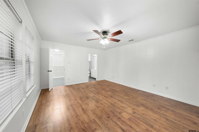 unfurnished bedroom featuring crown molding, ceiling fan, dark hardwood / wood-style flooring, and ensuite bath