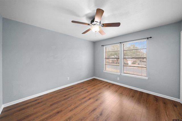 unfurnished room with dark wood-type flooring and ceiling fan