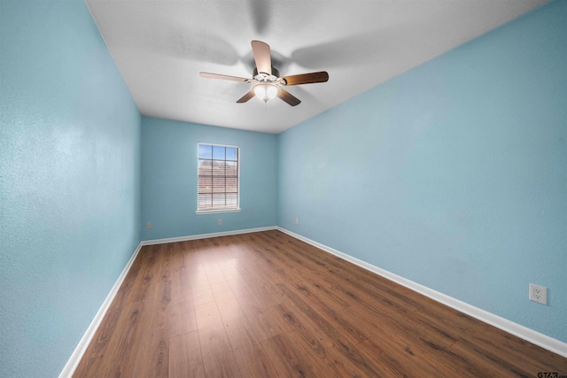 empty room featuring hardwood / wood-style flooring and ceiling fan