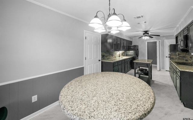 dining space with ornamental molding and ceiling fan