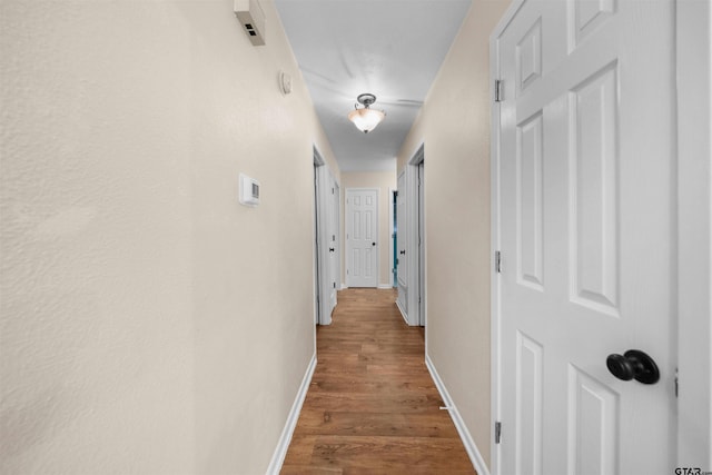 hall with hardwood / wood-style floors