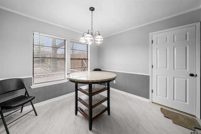 dining room with crown molding and a chandelier