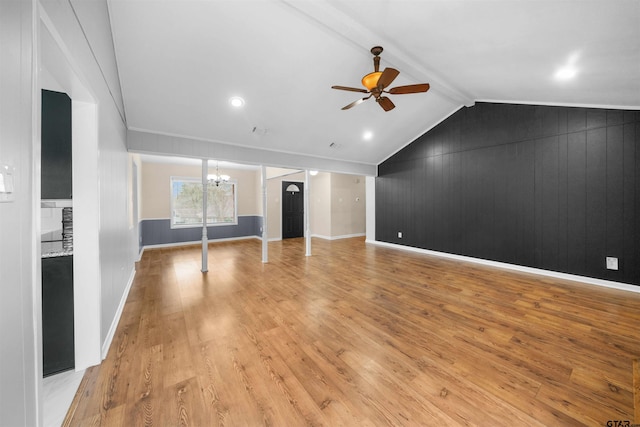 unfurnished living room with vaulted ceiling with beams, ceiling fan with notable chandelier, and light hardwood / wood-style floors