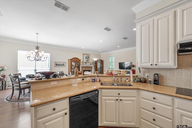 3953 Hanover Pl, Tyler, TX 75701 - kitchen featuring black appliances, a chandelier, backsplash, ornamental molding, and a fireplace