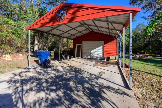 view of parking with a garage, a yard, and a carport