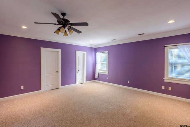 unfurnished room featuring carpet flooring, ceiling fan, and crown molding