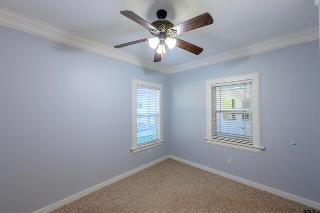 carpeted empty room featuring ornamental molding, plenty of natural light, and ceiling fan