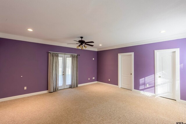 carpeted empty room with ceiling fan and ornamental molding