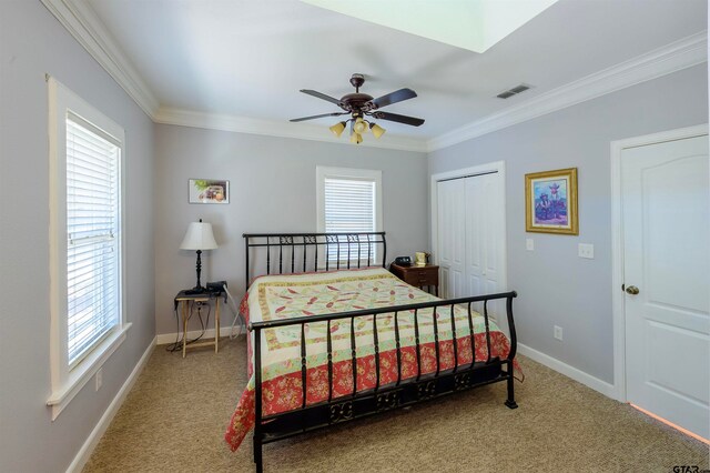 bedroom featuring ceiling fan, multiple windows, carpet floors, and crown molding