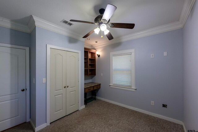 unfurnished bedroom featuring carpet flooring, ceiling fan, and crown molding