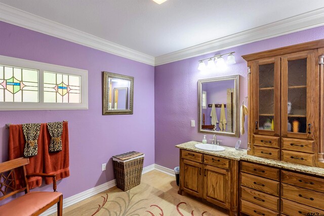 bathroom with vanity and crown molding