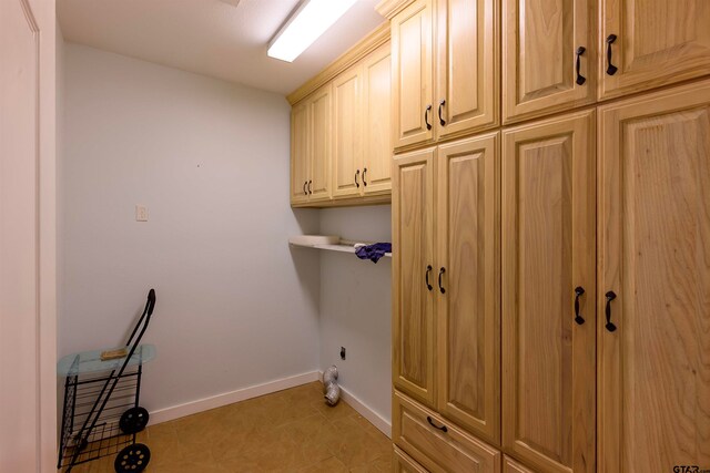 washroom with cabinets and light tile patterned floors